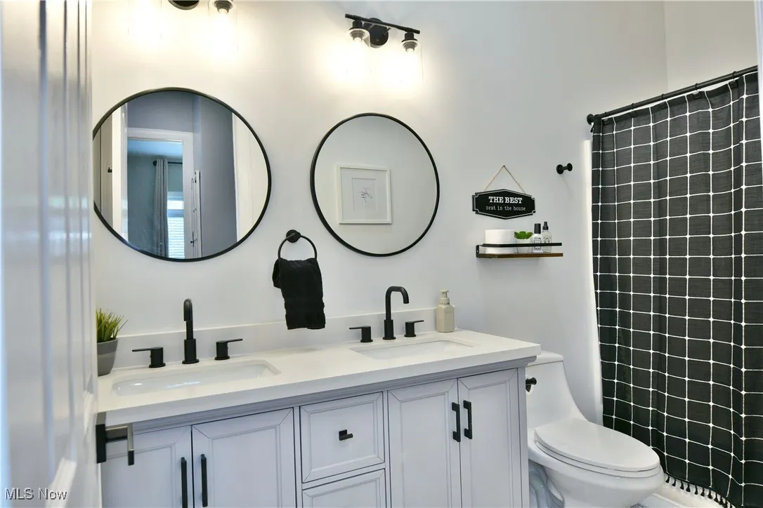 Bathroom with double vanity and a tile shower