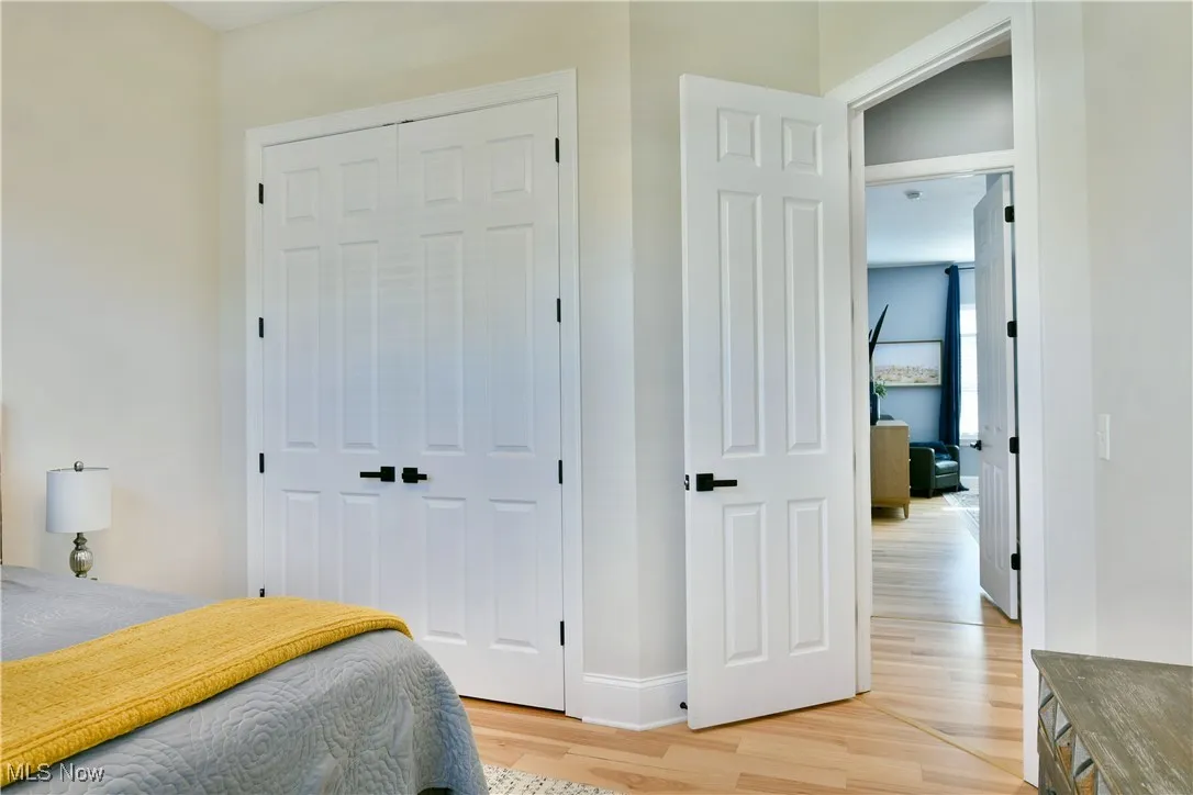 Bedroom with light wood-style flooring and a closet