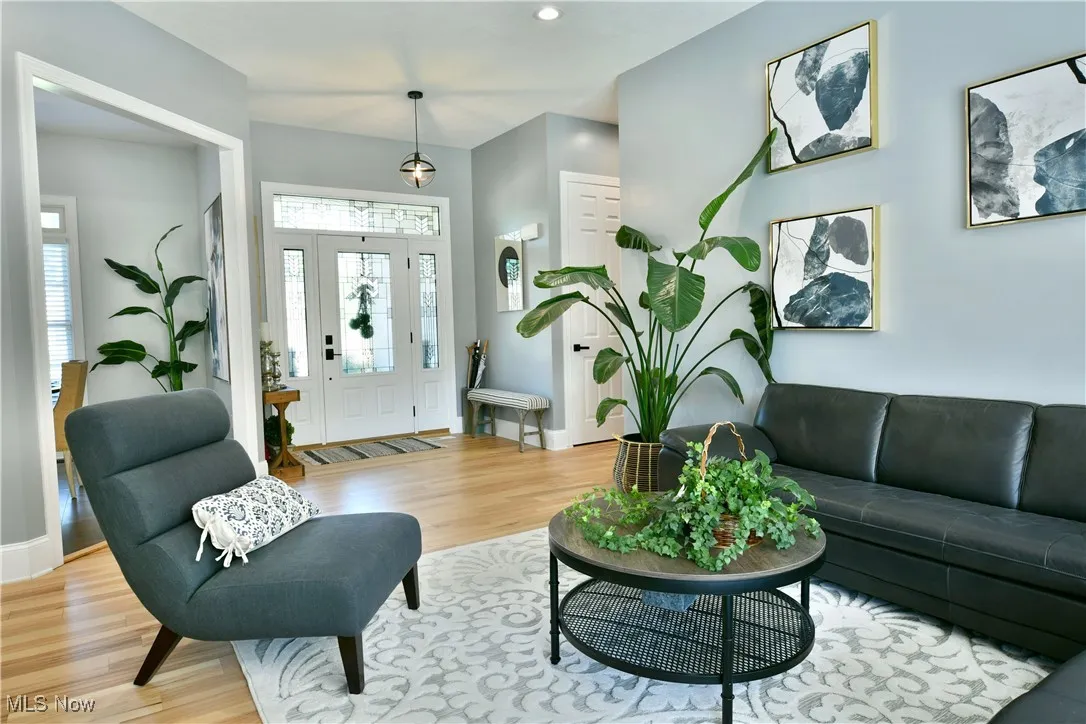 Living room featuring light wood finished floors and recessed lighting