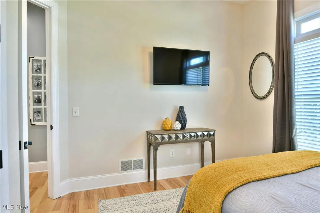 Bedroom featuring wood finished floors and baseboards