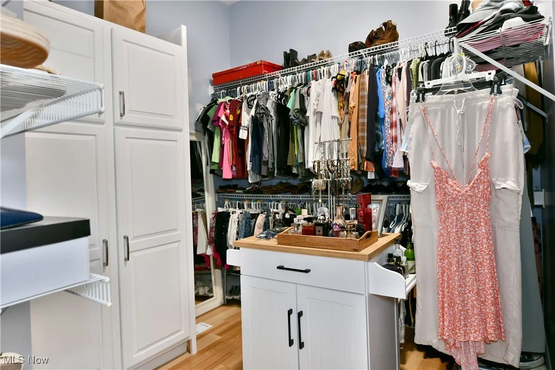 Spacious closet featuring light wood-style floors
