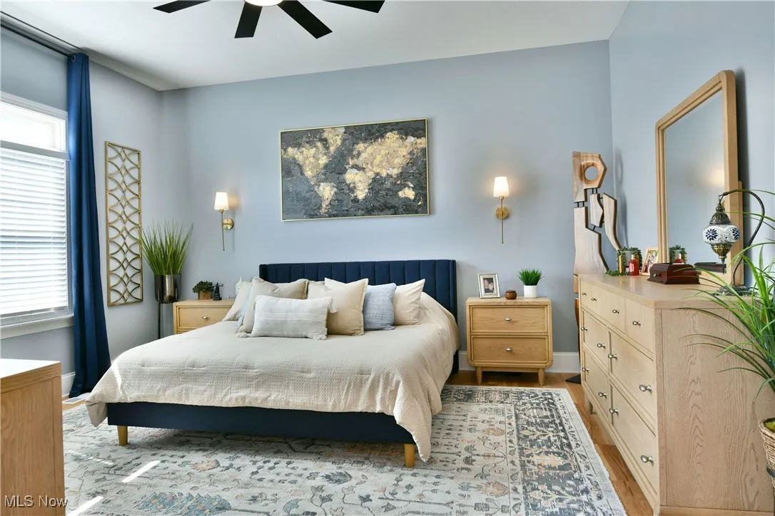 Bedroom with light wood-type flooring and a ceiling fan