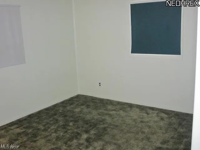 Empty room with dark carpet