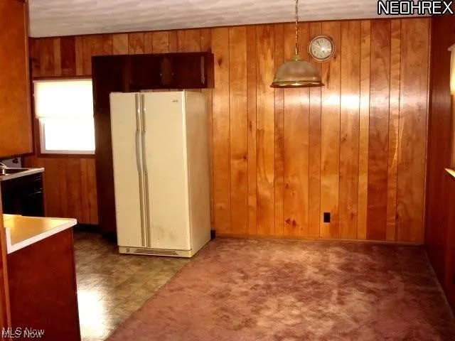 Unfurnished dining area with wooden walls