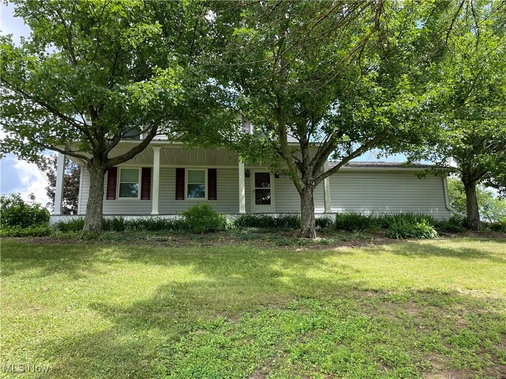 View of front of house with a porch and a front lawn