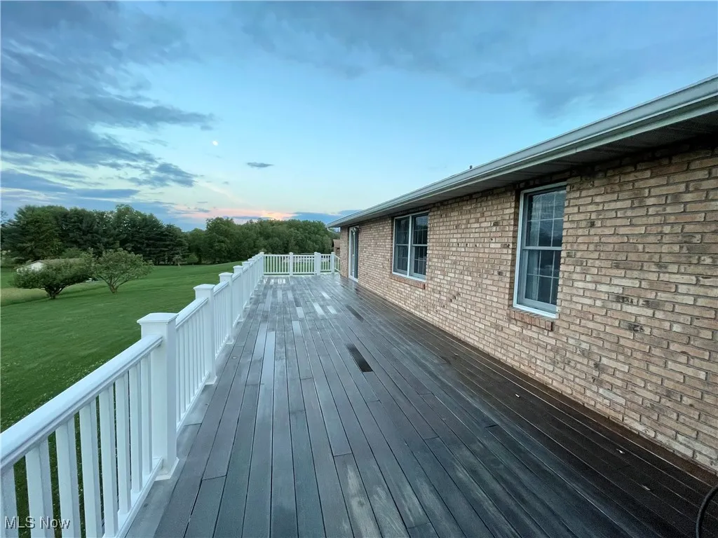Back deck runs the length of the house, has 2 sets of steps and offers panoramic views of Nature