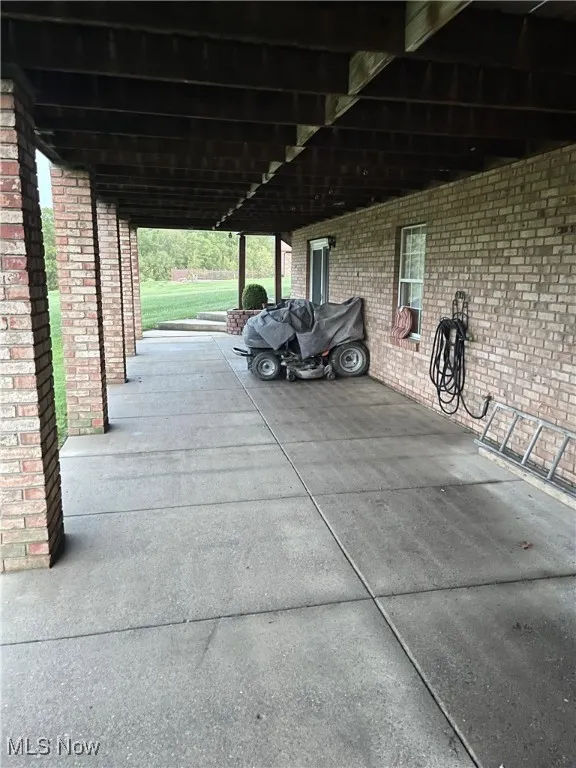Large lower level patio with mower, which also remains with the property