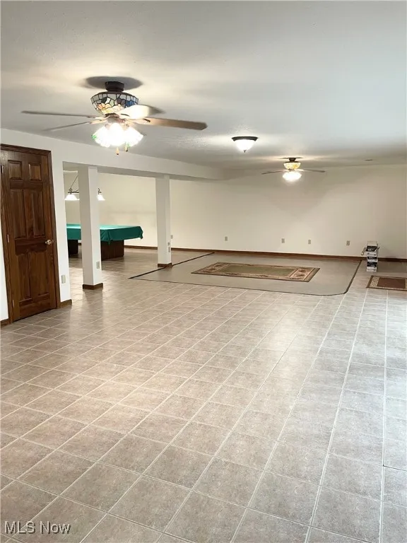 Large open room on lower level features ceramic tile floors
