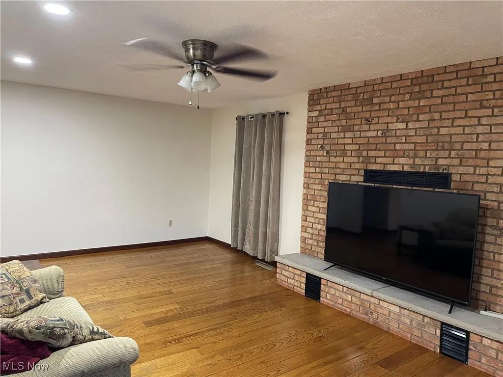 Hardwood in the Family room- fireplace behind TV