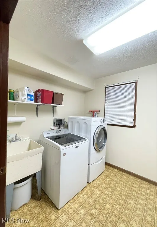 Main floor laundry room with sink and storage