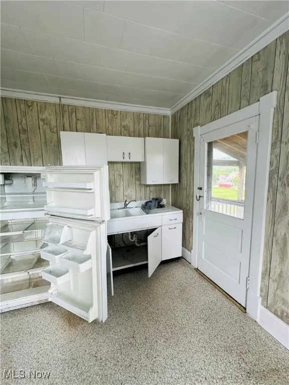 Spare room with carpet floors and arched walkways