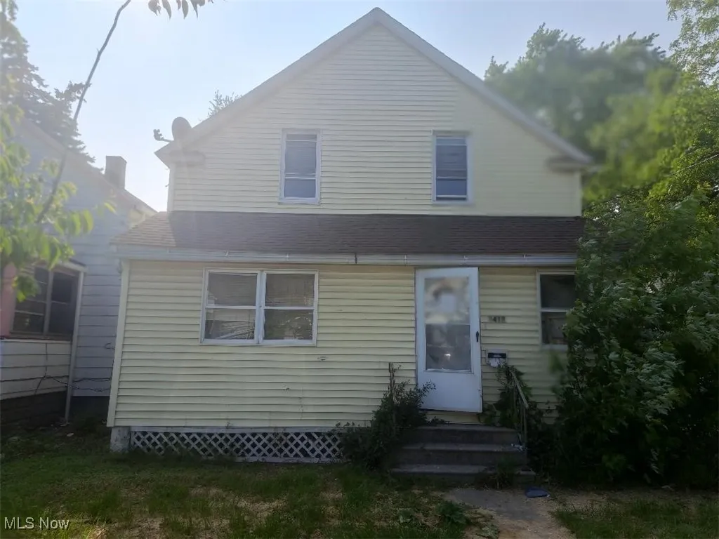 View of front of home featuring a shingled roof