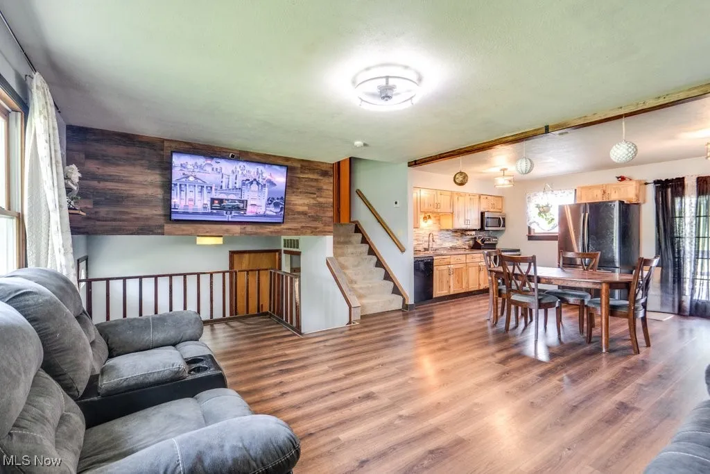 Living room featuring wood finished floors and stairs