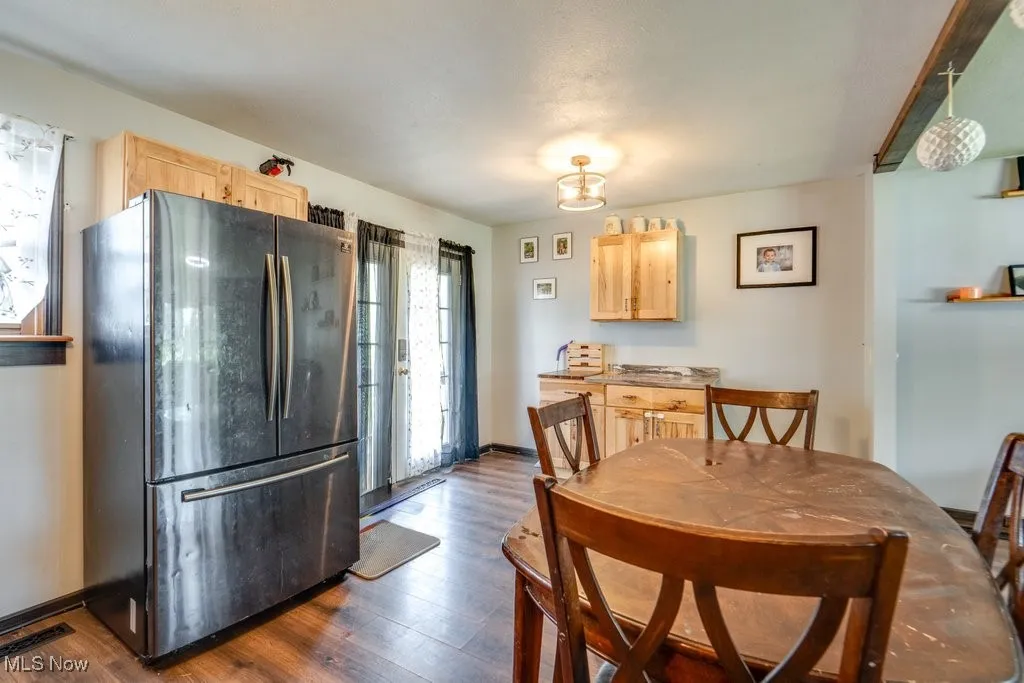 Dining room featuring dark wood-style floors and baseboards