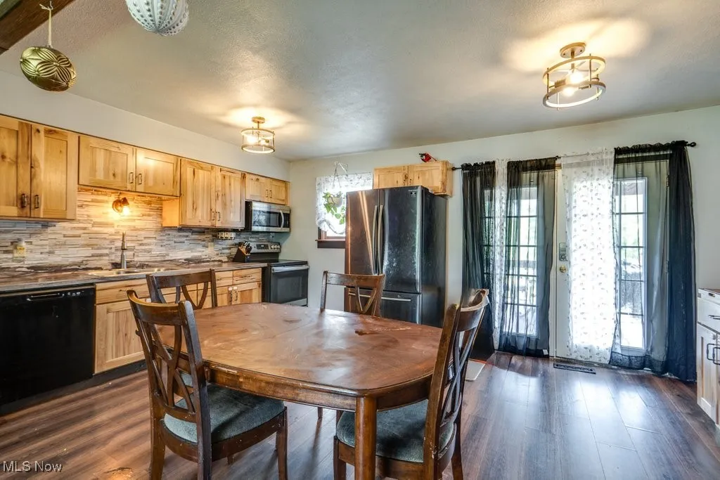 Dining area with dark wood-style floors