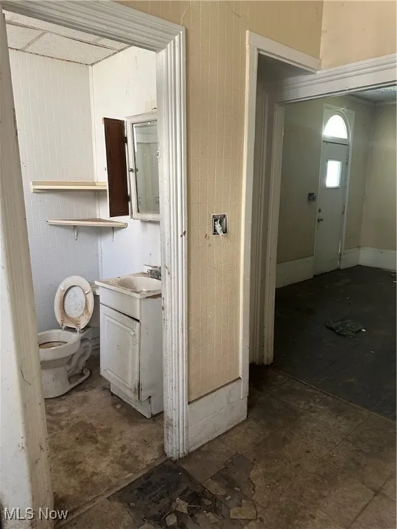 Half bathroom with vanity and toilet