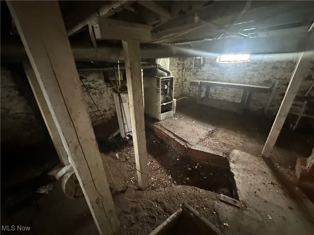Unfinished basement featuring heating unit