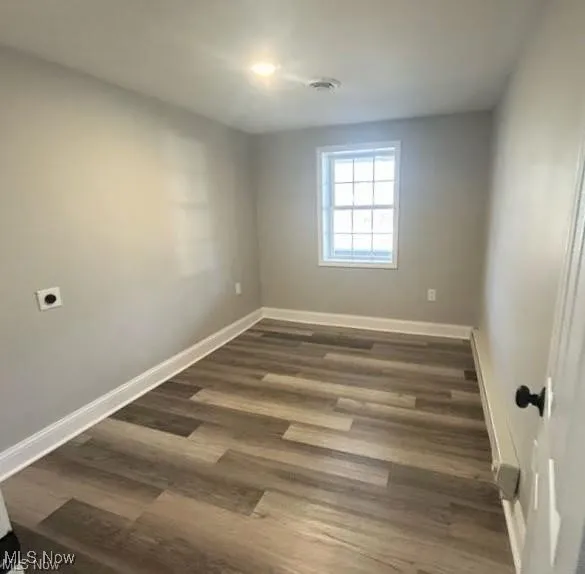 Empty room with dark wood-style floors