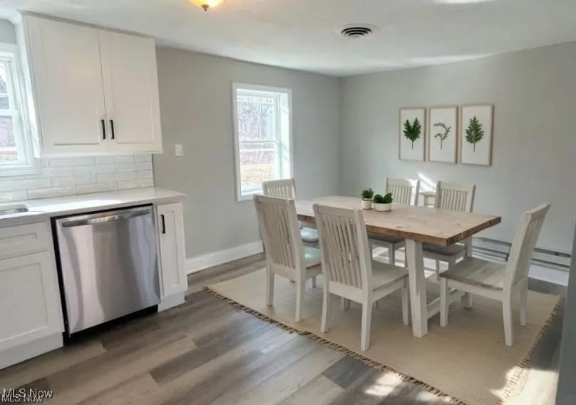 Dining room featuring light wood finished floors and baseboards