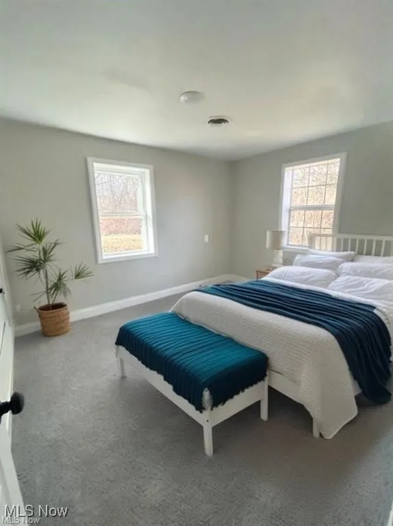 Bedroom featuring carpet floors and baseboards