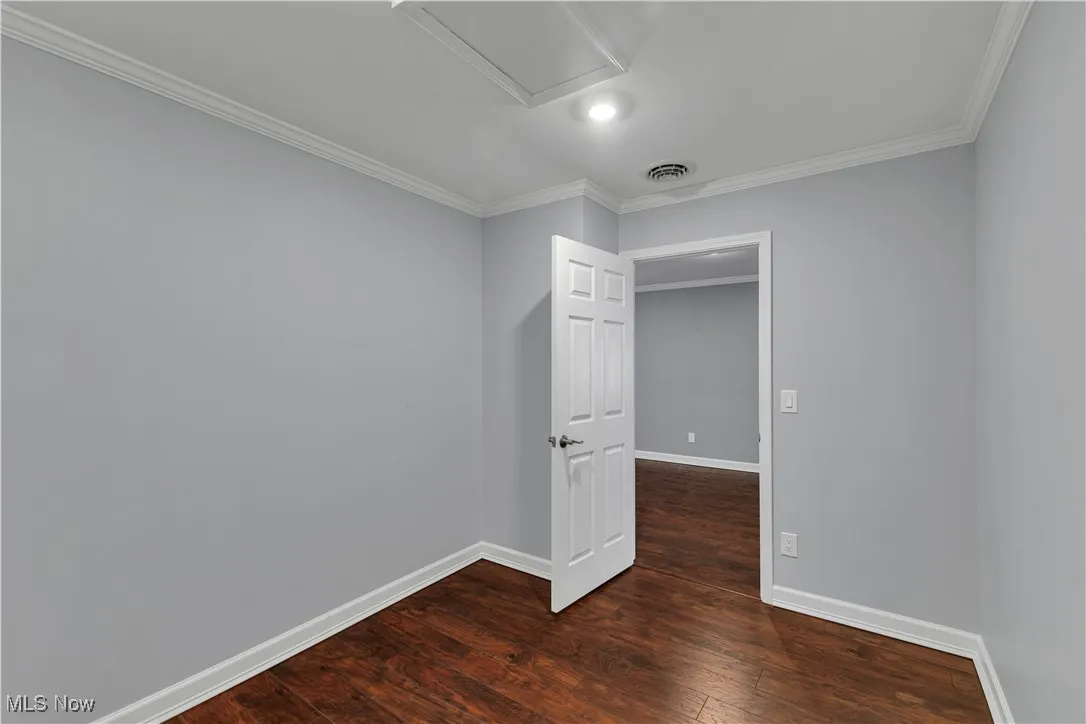 Flex room with crown molding and wood finished floors