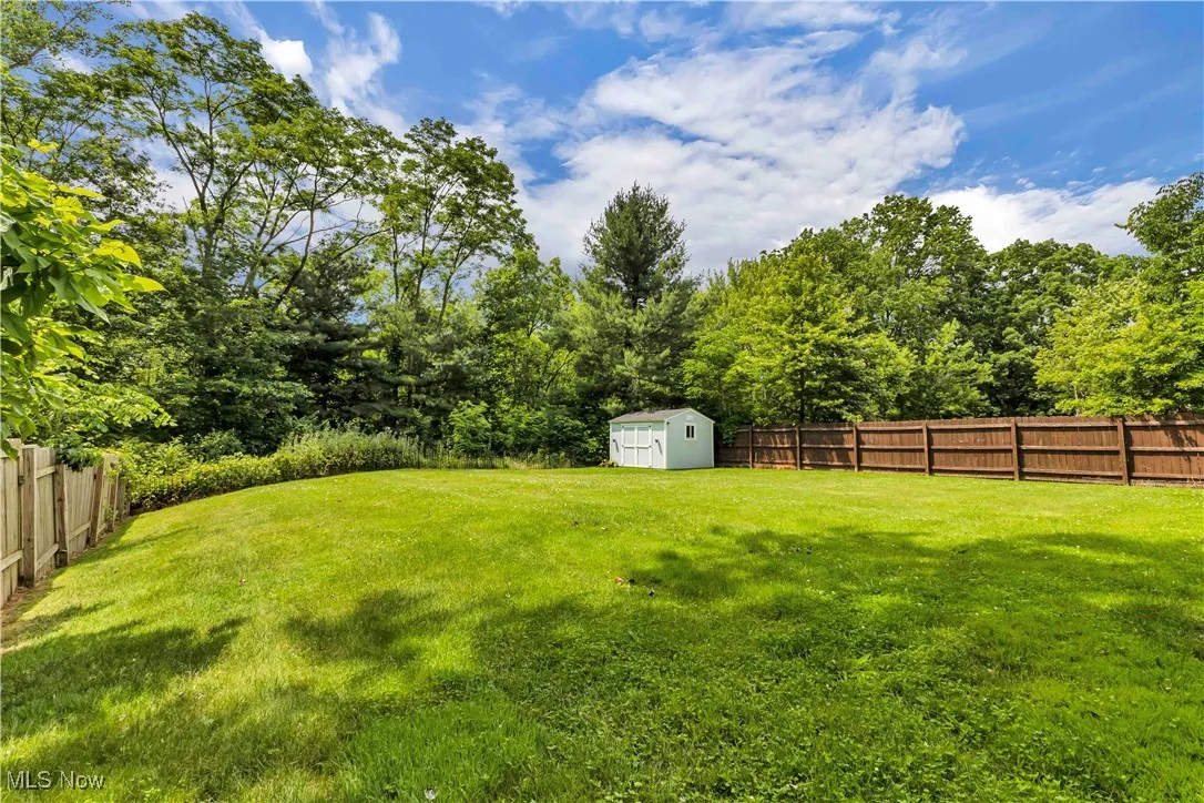 Fenced backyard with a storage shed