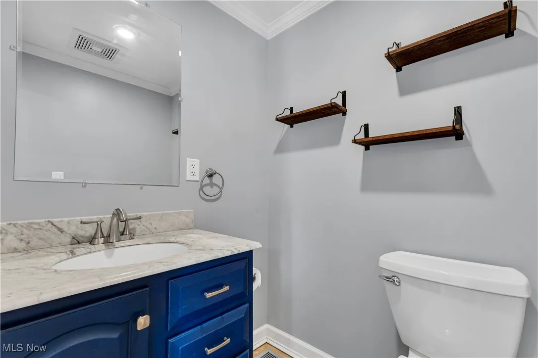 Modern half bathroom located on main floor near laundry room