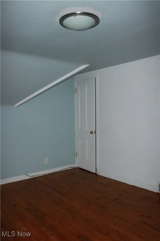 Bonus room featuring dark wood-type flooring