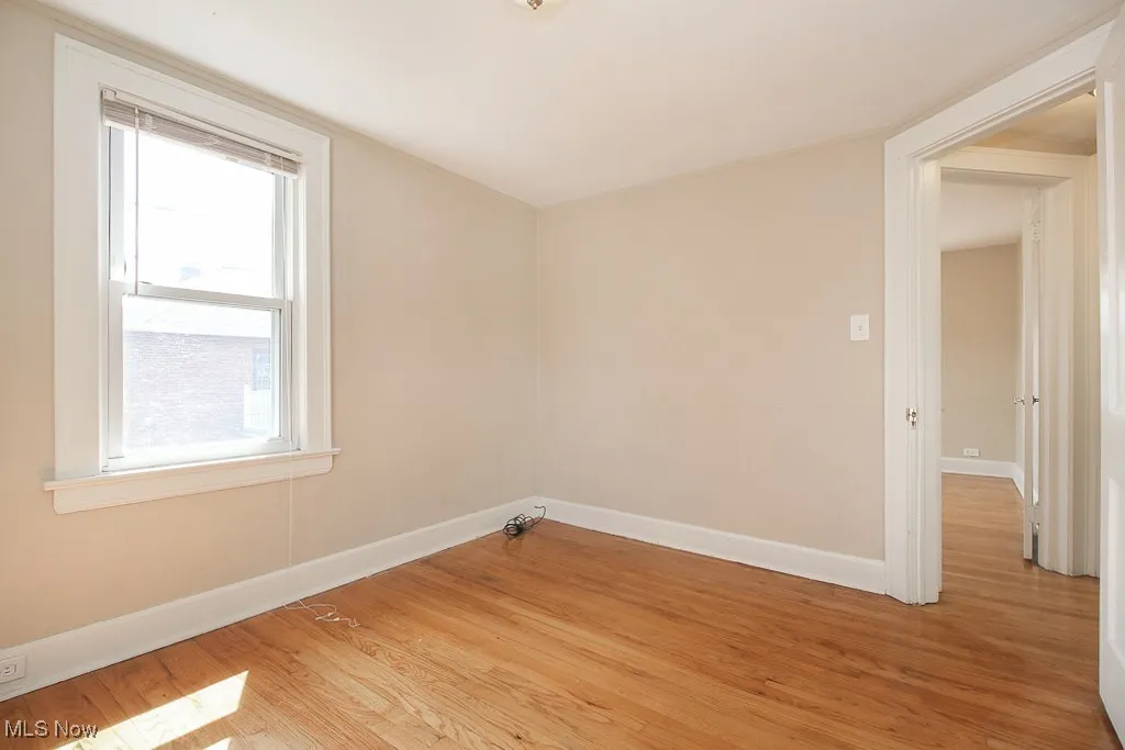 Empty room featuring light wood-style floors and plenty of natural light