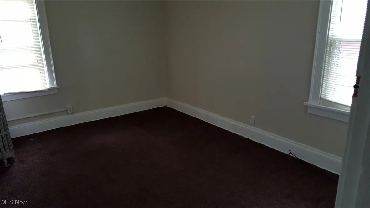 Empty room with dark carpet