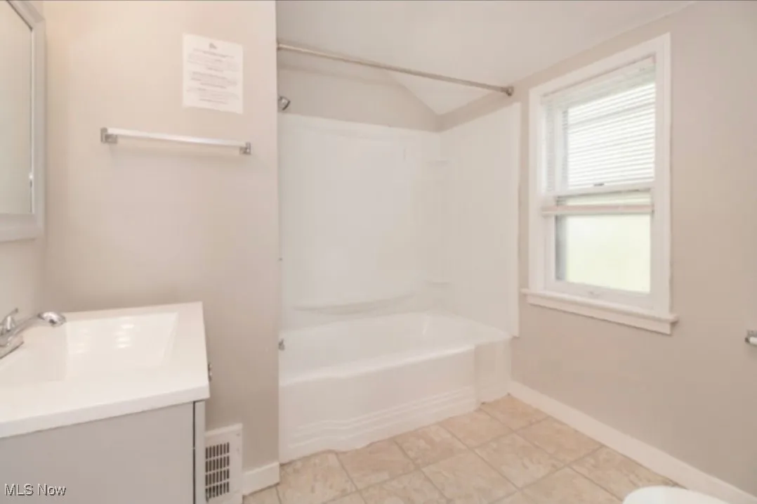 Full bathroom featuring shower / bathtub combination, vanity, and tile patterned floors