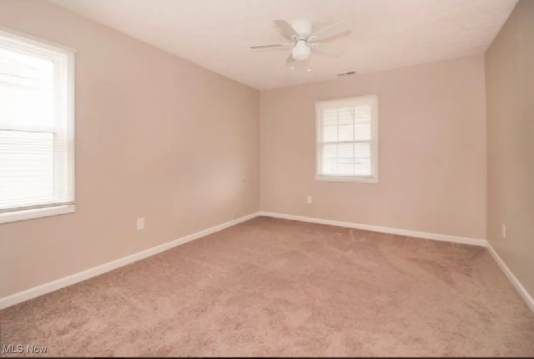 Unfurnished room with carpet flooring and a ceiling fan