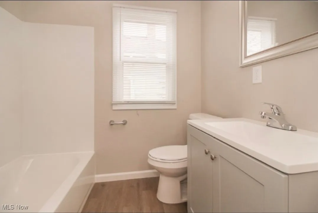 Bathroom with vanity and wood finished floors