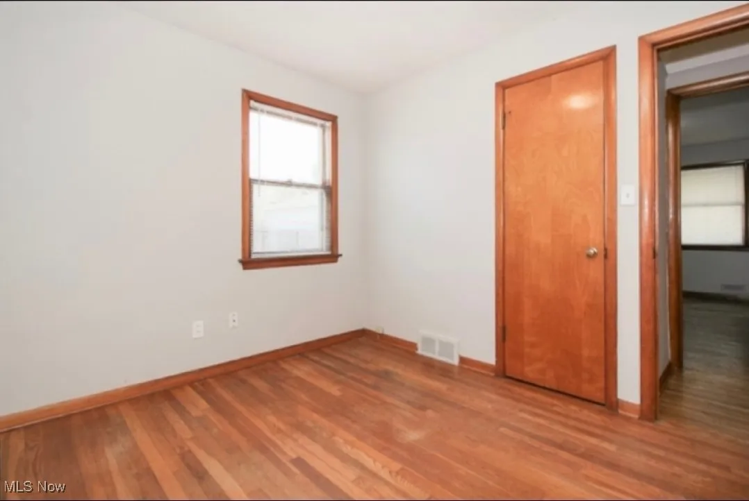 Unfurnished bedroom with wood finished floors