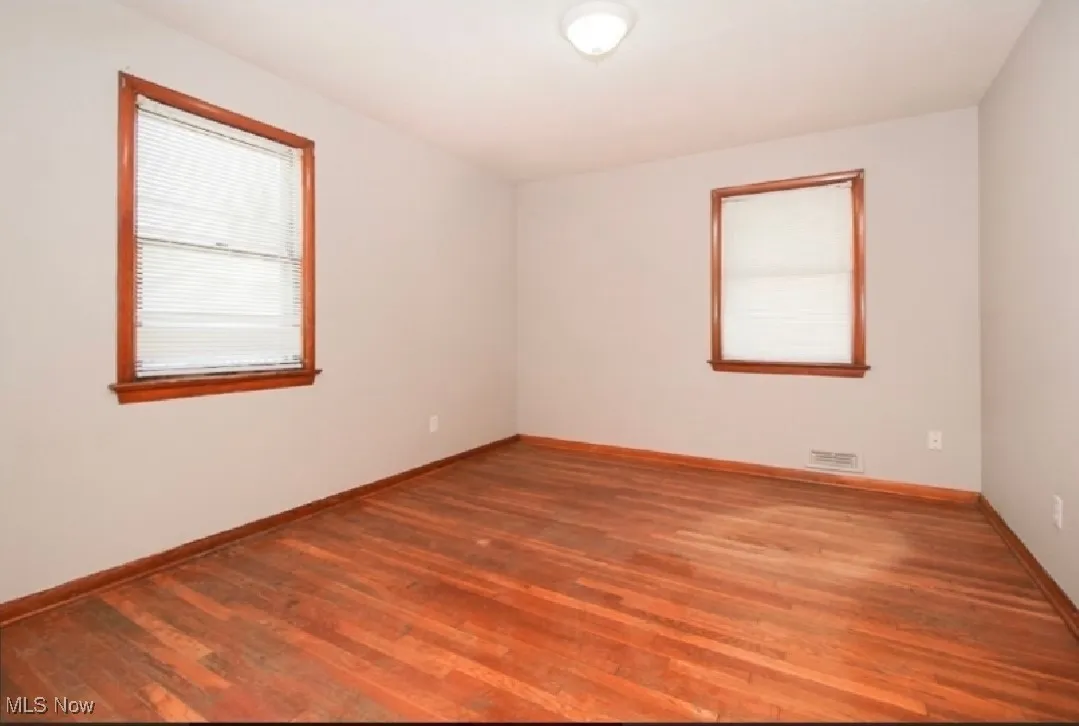 Empty room featuring wood finished floors and baseboards