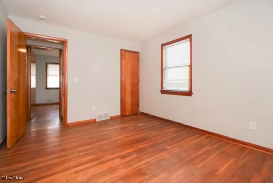 Empty room with wood finished floors and baseboards