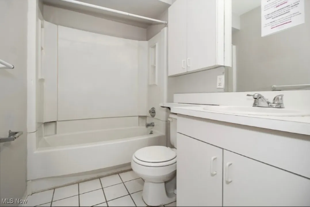 Full bath with vanity, bathtub / shower combination, and tile patterned flooring