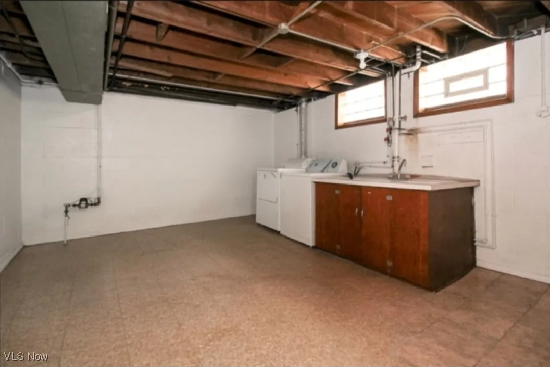 Basement with separate washer and dryer and light floors
