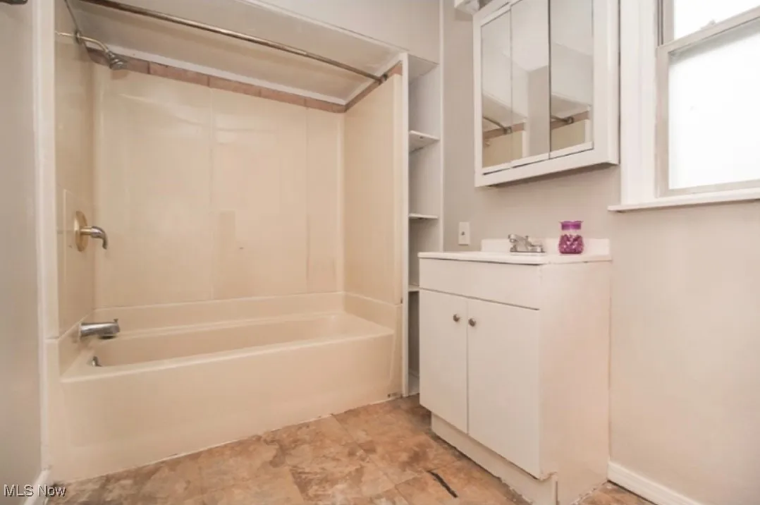 Full bathroom featuring vanity and washtub / shower combination
