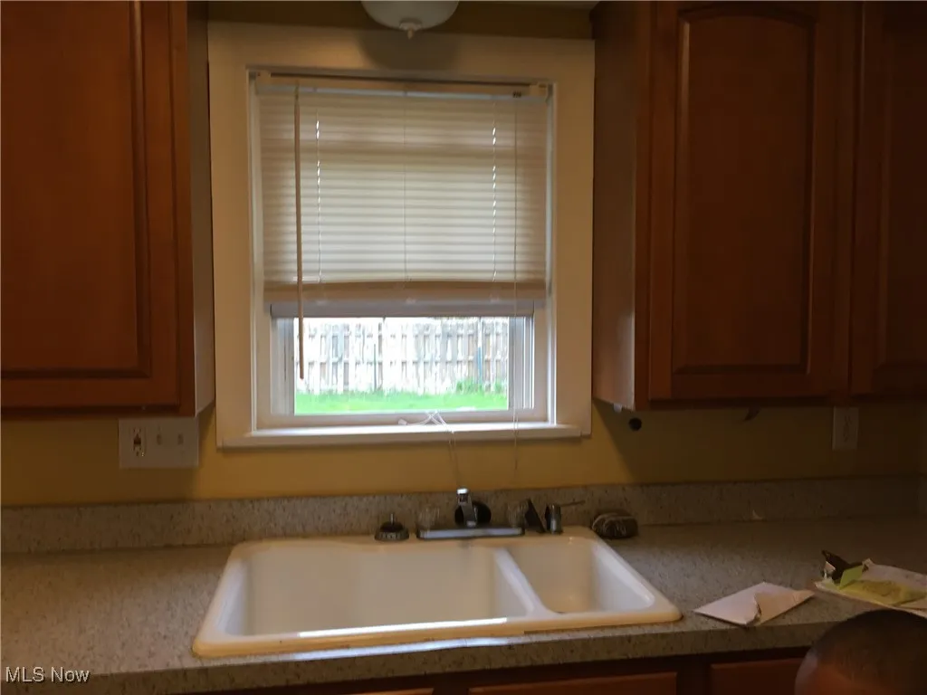 Kitchen featuring light countertops and brown cabinets