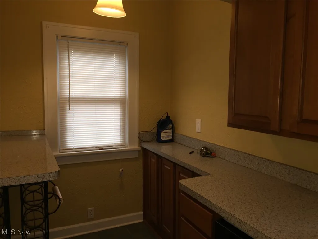 Kitchen featuring light countertops and dark tile patterned floors