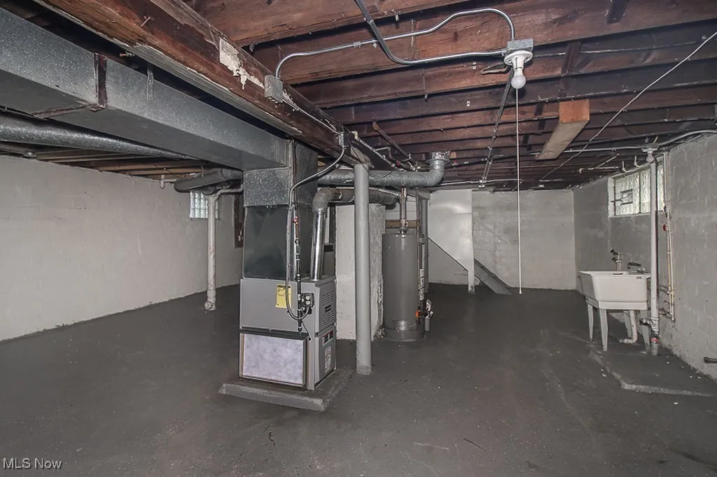 Basement featuring gas water heater and heating unit