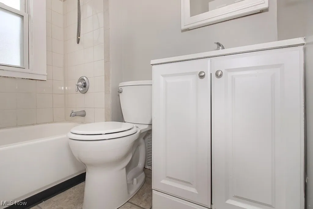 Full bathroom featuring vanity, shower / bathtub combination, and tile patterned floors