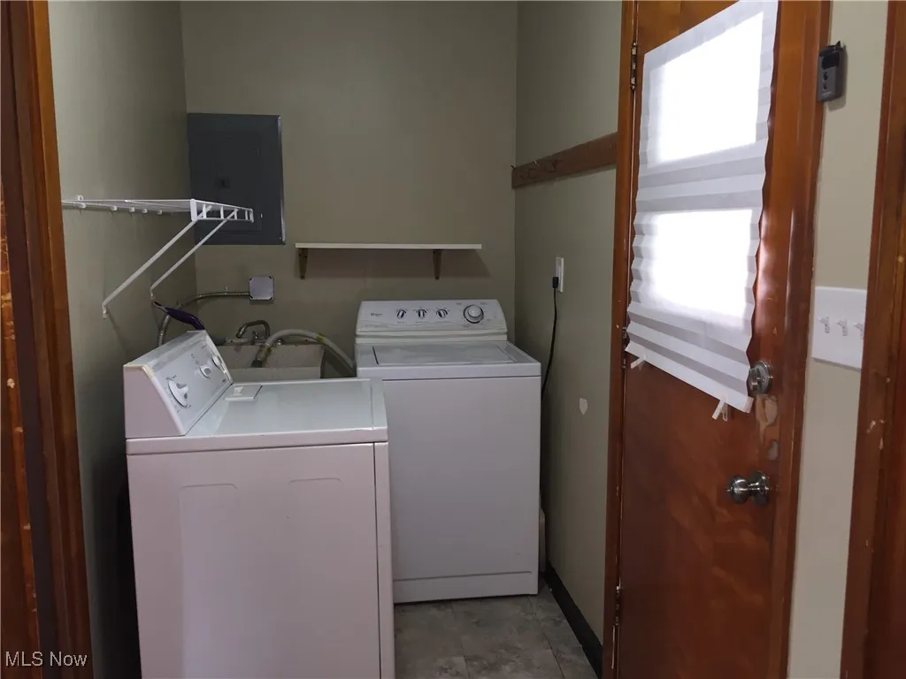 Laundry room with separate washer and dryer and electric panel