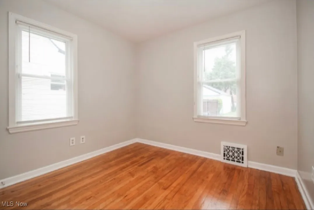 Empty room featuring light wood-type flooring and baseboards