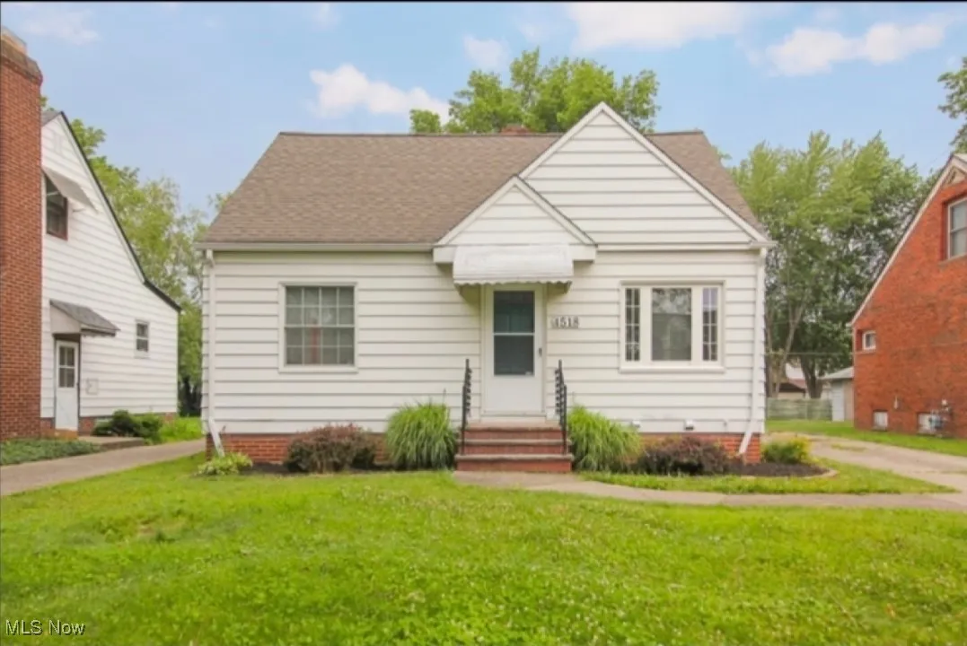Bungalow featuring a front yard and roof with shingles