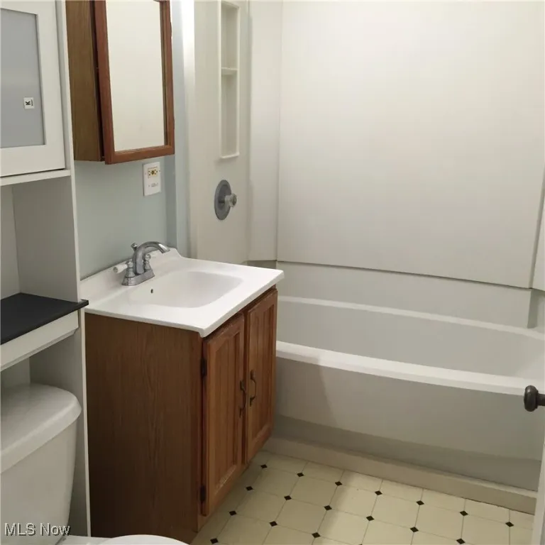 Full bathroom featuring vanity and tile patterned floors