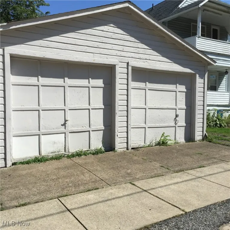 Garage featuring concrete driveway