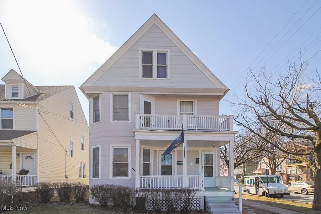 View of front of house with a porch and a balcony