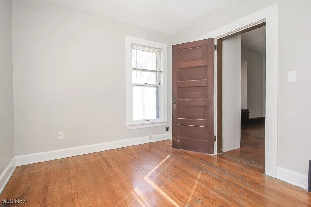 Unfurnished room featuring wood finished floors and​​‌​​​​‌​​‌‌​‌‌​​​‌‌​‌​‌​‌​​​‌​​ baseboards